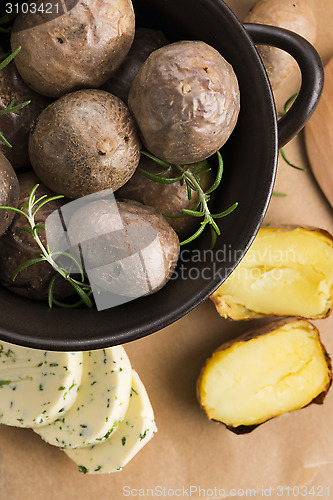 Image of  baked potatoes with herbs butter