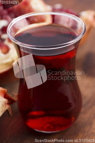 Image of Ripe pomegranates with juice on table
