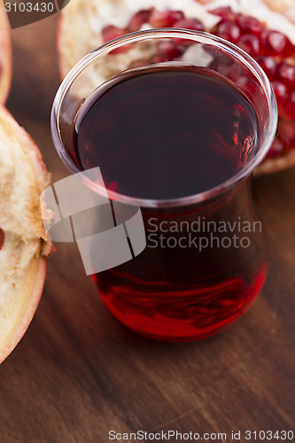 Image of Ripe pomegranates with juice on table