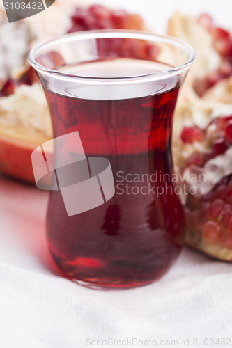 Image of Ripe pomegranates with juice on table