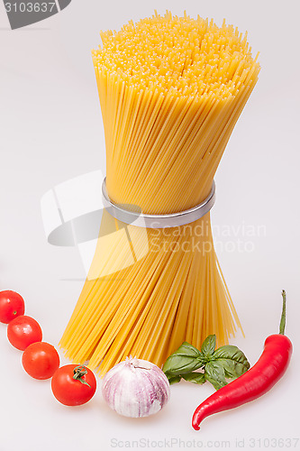 Image of Spaghetti standing with fresh spices and vegetables, raw