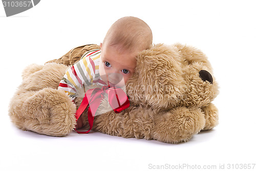 Image of baby boy over plush dog on white background