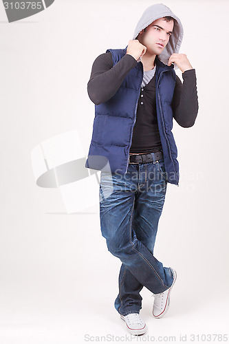 Image of Relaxed charismatic young man in a hooded top