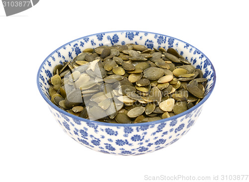 Image of Pumpkin seeds in a blue and white china bowl