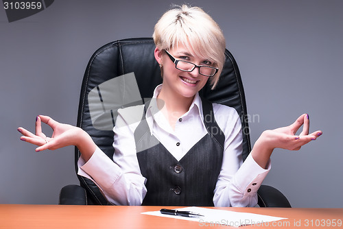 Image of Blond businesswoman meditating