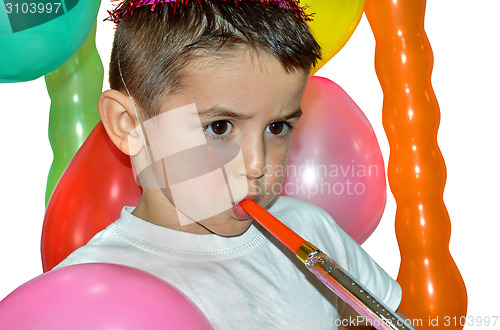 Image of Happy boy play with air whistle