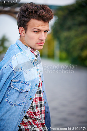 Image of Handsome man outdoors over urban background