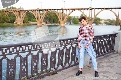 Image of Handsome man outdoors over urban background