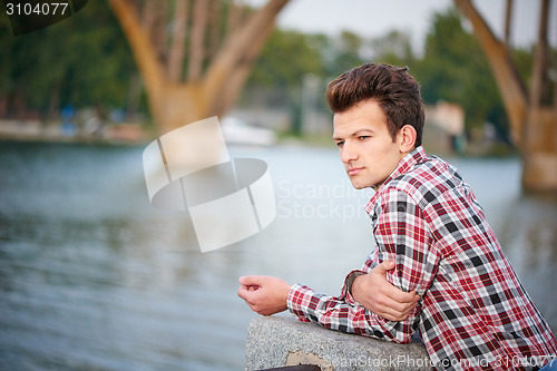 Image of Handsome man outdoors over urban background