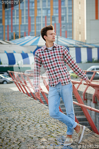 Image of Handsome man outdoors over urban background