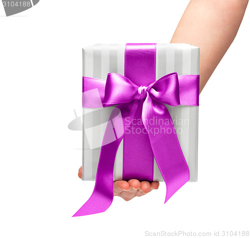 Image of male holding gift box with a bow