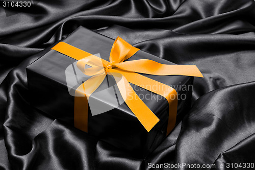Image of Black gift box with yellow satin ribbon and bow