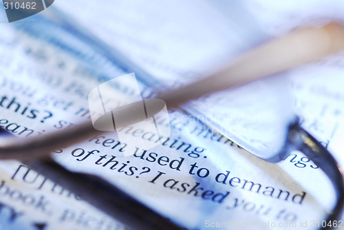 Image of open book and eyeglasses