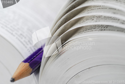 Image of open book with pencil