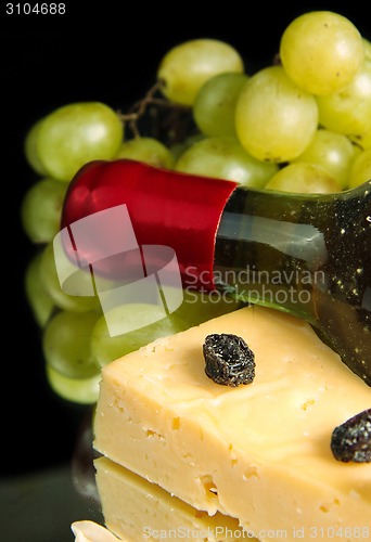 Image of Grape wine with cheese on black