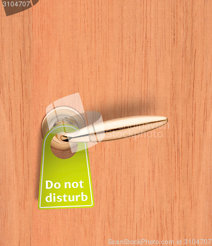 Image of Hotel wood door with a Do not disturb sign