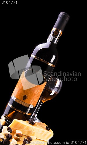 Image of wine bottle with glass and cheese