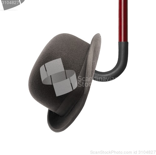 Image of walking stick and black bowler cap