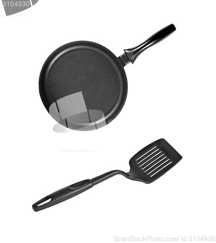 Image of Pan with black plastic kitchen spatula