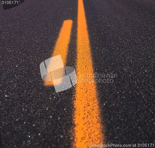 Image of Asphalt road texture with yellow stripe