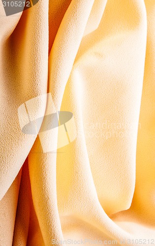 Image of background of bright yellow silk with waves