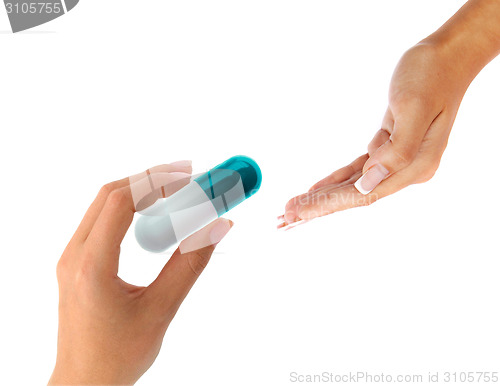 Image of hand gives a big pill