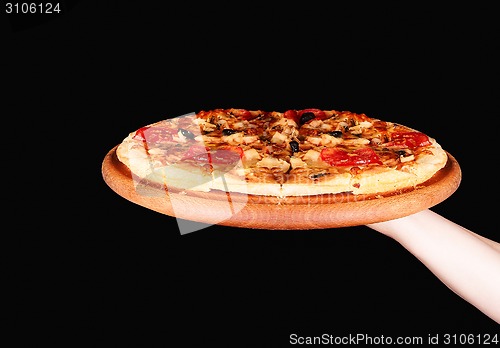 Image of Tasty pizza in wooden plate