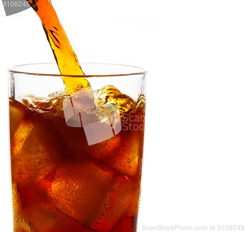 Image of Cola is pouring into glass on white background
