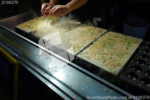 Image of Takoyaki chefs prepare takoyaki 