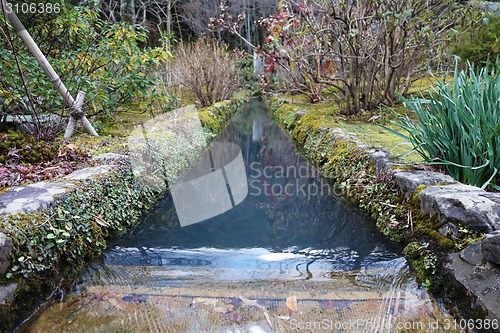 Image of Japanese style garden with running clear water