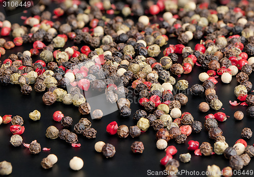 Image of Red, black, green and white peppercorns
