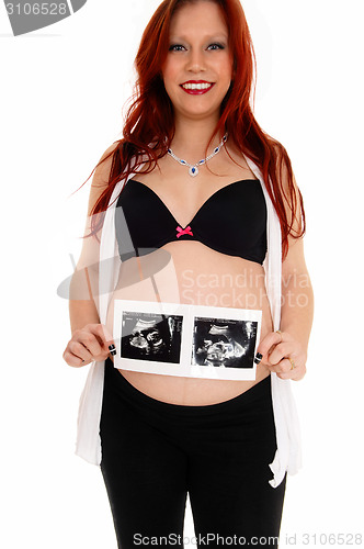 Image of Happy girl with ultrasound picture.