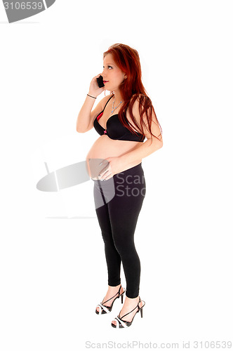 Image of Pregnant woman on cell phone.