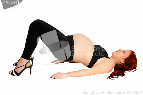 Image of Pregnant woman making bridge.