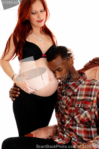 Image of Man listening on baby belly.