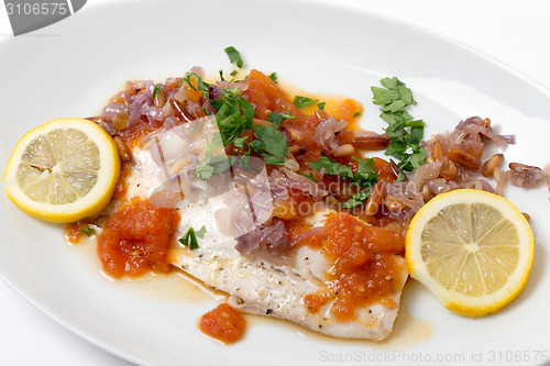 Image of Baked fish with tomato sauce, onion, pine nuts