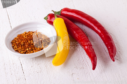 Image of Fresh red and yellow chili peppers with spice