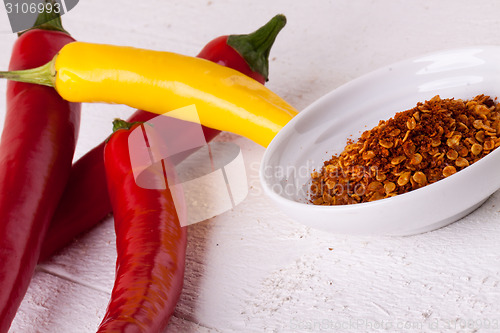 Image of Fresh red and yellow chili peppers with spice