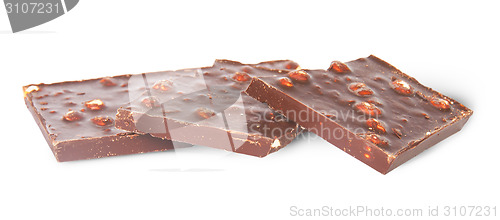 Image of Several pieces of dark chocolate with hazelnuts