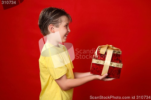 Image of Smiling boy giving Christmas presents
