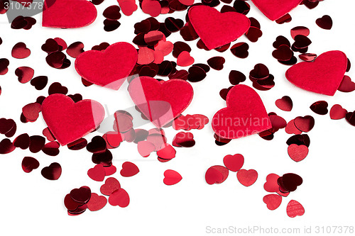 Image of Red hearts confetti and fabric heart on white background