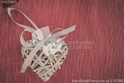 Image of valentine's wooden hearts on a fabric background in retro color