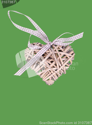 Image of valentine's wooden hearts isolated on green background