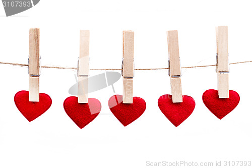 Image of Red fabric heart hanging on the clothesline