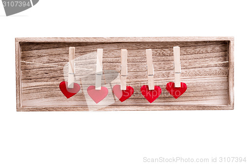 Image of Red fabric heart hanging on the clothesline