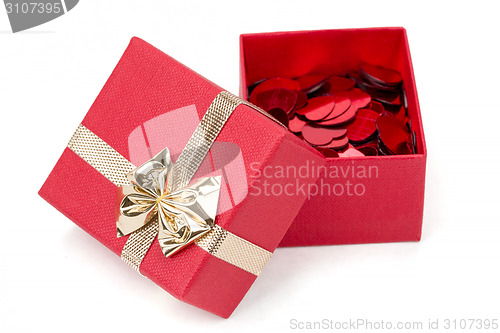 Image of Red hearts confetti in box on white background