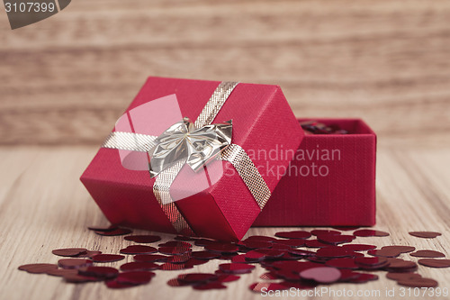 Image of Red hearts confetti on wooden background