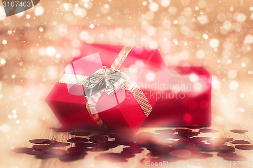 Image of Red hearts confetti on abstract bokeh background
