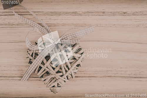 Image of valentine's wooden hearts on a wooden background in retro color