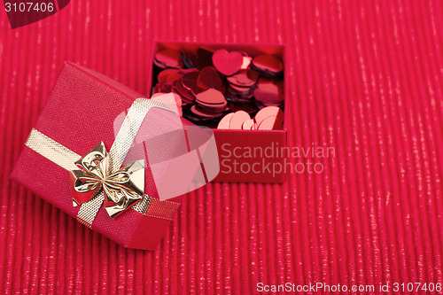 Image of Red hearts confetti on fabric background